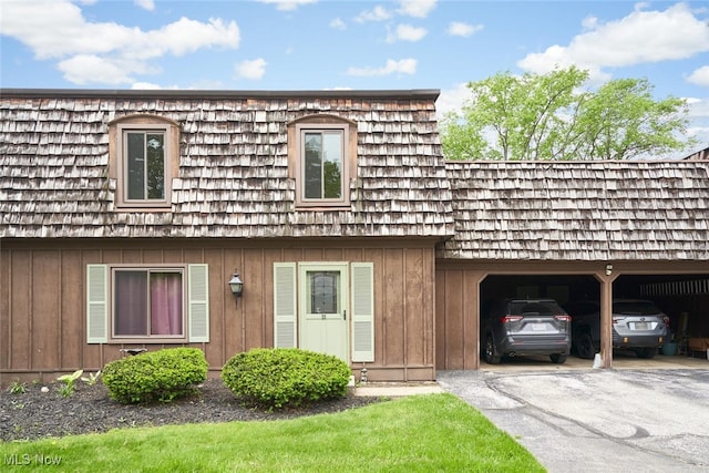 200 Granger Rd, Medina, OH 44256 - view of front of home with board and batten siding, mansard roof, and asphalt driveway