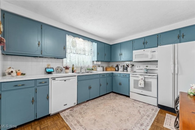 5725 Grove St, Louisville, OH 44641 - kitchen featuring white appliances, blue cabinets, a sink, a textured ceiling, and light countertops