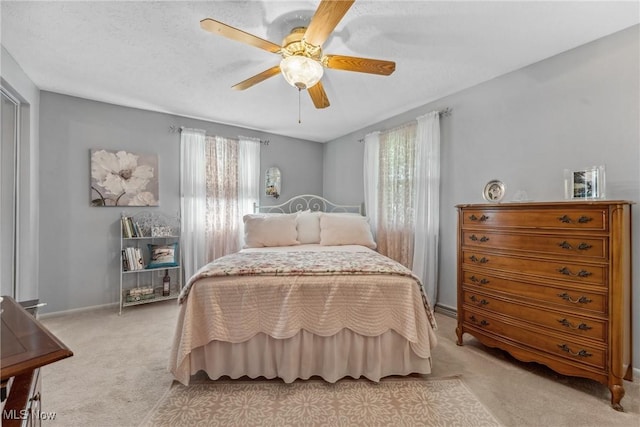 5725 Grove St, Louisville, OH 44641 - bedroom with light carpet, multiple windows, baseboards, and ceiling fan