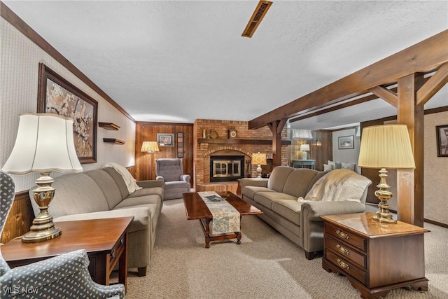 5725 Grove St, Louisville, OH 44641 - carpeted living area featuring crown molding, wood walls, a fireplace, and a textured ceiling