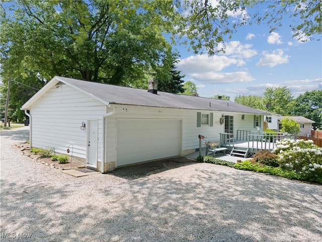 5725 Grove St, Louisville, OH 44641 - single story home featuring a deck, a garage, and driveway
