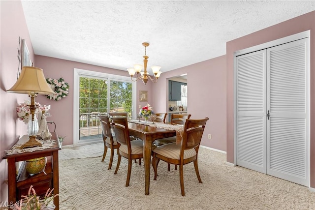 5725 Grove St, Louisville, OH 44641 - dining room featuring a chandelier, a textured ceiling, light colored carpet, and baseboards