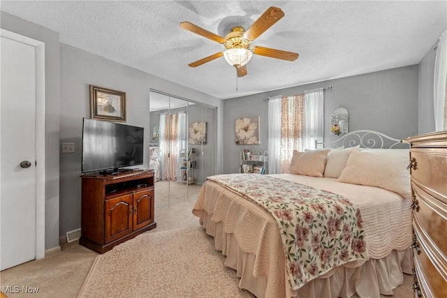 5725 Grove St, Louisville, OH 44641 - bedroom with multiple windows, light colored carpet, a closet, and a ceiling fan