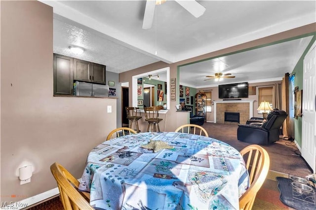 459 Lloyd Rd, Euclid, OH 44132 - dining space featuring ceiling fan, dark colored carpet, and a fireplace