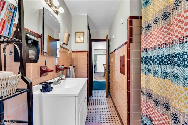 459 Lloyd Rd, Euclid, OH 44132 - full bath featuring tile walls, vanity, tile patterned floors, a shower with curtain, and a wainscoted wall