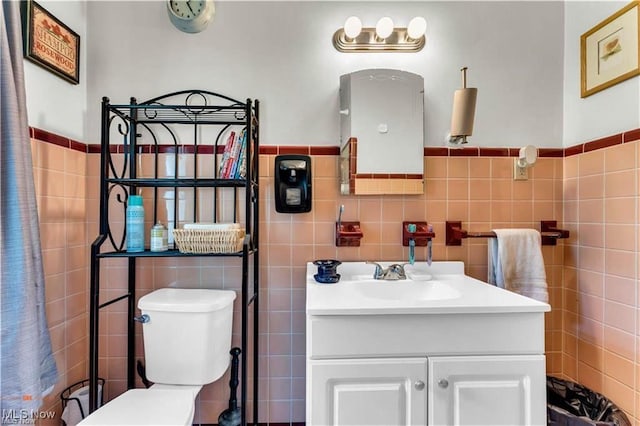 459 Lloyd Rd, Euclid, OH 44132 - bathroom featuring tile walls, vanity, toilet, and wainscoting