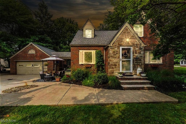 459 Lloyd Rd, Euclid, OH 44132 - english style home with stone siding, an attached garage, driveway, and brick siding