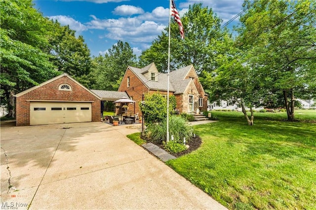 459 Lloyd Rd, Euclid, OH 44132 - view of front of home featuring a front lawn, concrete driveway, brick siding, and an attached garage