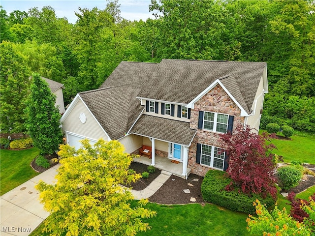 3425 Eryn Pl, Hudson, OH 44236 - view of front facade with stone siding, an attached garage, and a front yard