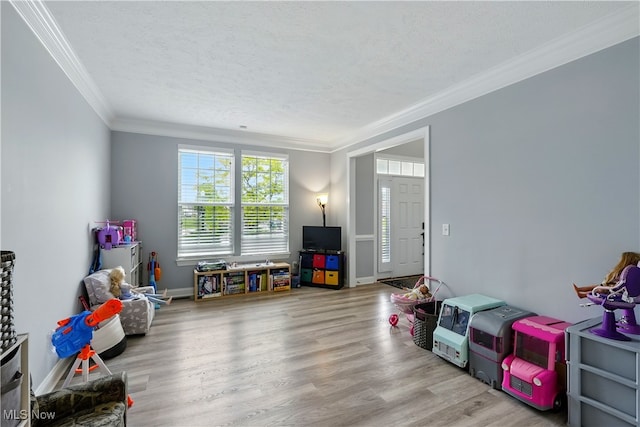 3425 Eryn Pl, Hudson, OH 44236 - rec room with ornamental molding, wood finished floors, a textured ceiling, and baseboards