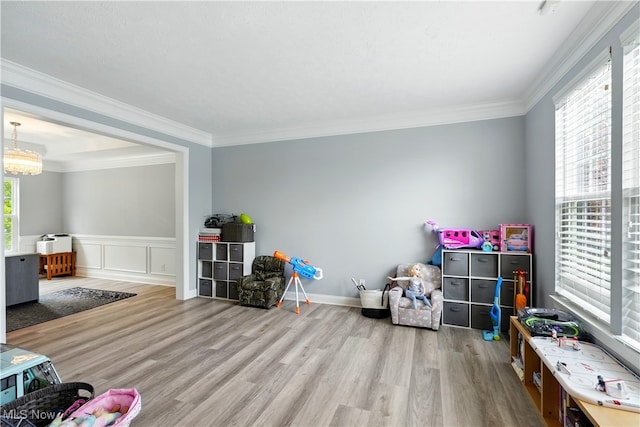 3425 Eryn Pl, Hudson, OH 44236 - recreation room with wood finished floors, crown molding, wainscoting, a chandelier, and a decorative wall