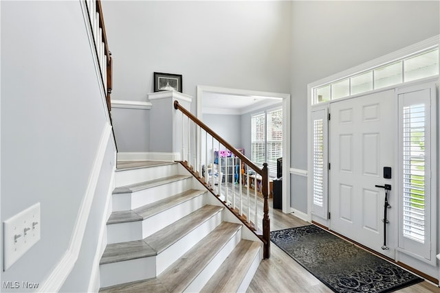 3425 Eryn Pl, Hudson, OH 44236 - foyer with light wood-style floors, stairway, plenty of natural light, a high ceiling, and crown molding