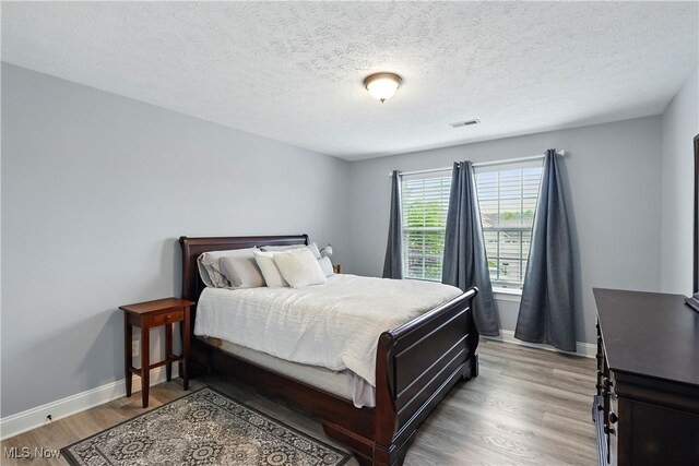 3425 Eryn Pl, Hudson, OH 44236 - bedroom featuring baseboards, light wood-style flooring, and a textured ceiling