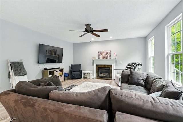 3425 Eryn Pl, Hudson, OH 44236 - living room with wood finished floors, a ceiling fan, a glass covered fireplace, and recessed lighting