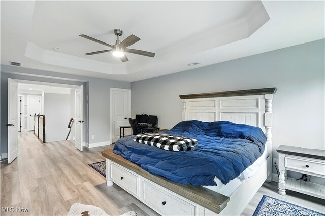 3425 Eryn Pl, Hudson, OH 44236 - bedroom featuring a tray ceiling, light wood-style flooring, baseboards, ornamental molding, and ceiling fan