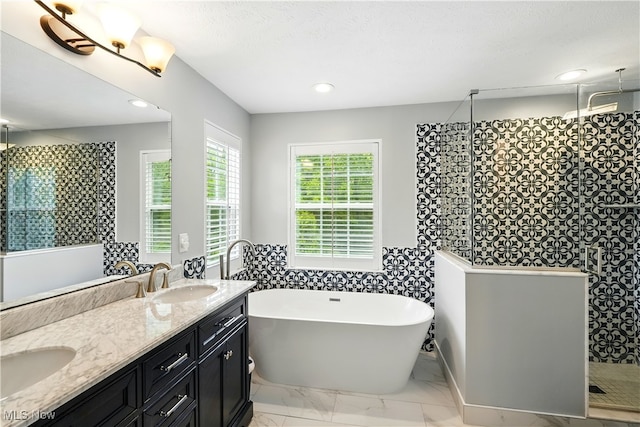 3425 Eryn Pl, Hudson, OH 44236 - bathroom featuring a tile shower, double vanity, a freestanding bath, marble look tiles, and recessed lighting
