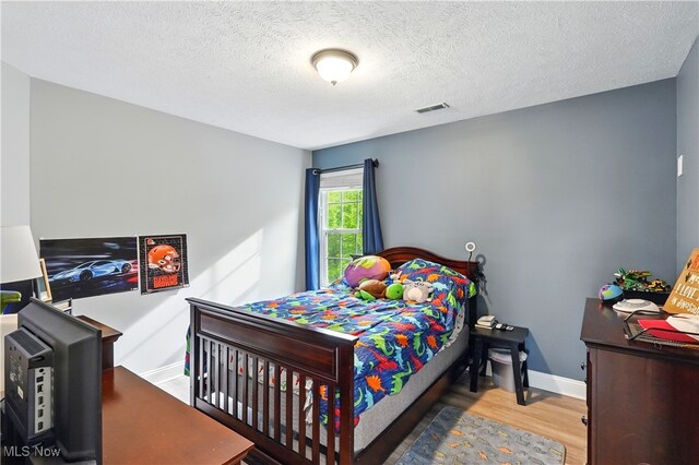 3425 Eryn Pl, Hudson, OH 44236 - bedroom featuring wood finished floors, baseboards, and a textured ceiling
