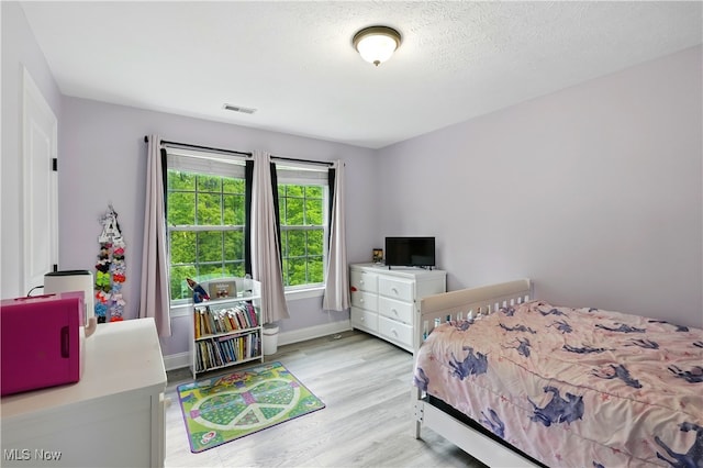 3425 Eryn Pl, Hudson, OH 44236 - bedroom featuring light wood-style floors, baseboards, and a textured ceiling