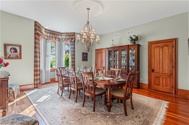 9627 State Route 152, Richmond, OH 43944 - dining area with a chandelier, wood finished floors, and baseboards
