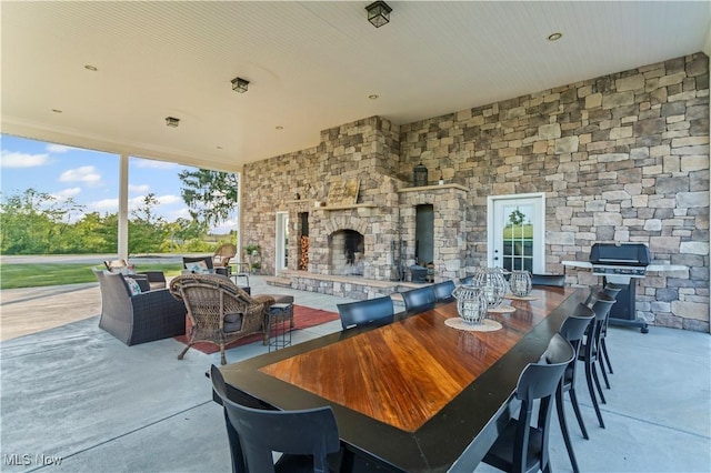9627 State Route 152, Richmond, OH 43944 - view of patio / terrace with area for grilling, outdoor dining space, and an outdoor living space with a fireplace