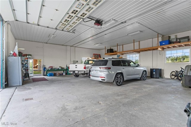 9627 State Route 152, Richmond, OH 43944 - garage featuring a garage door opener and freestanding refrigerator