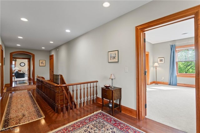 9627 State Route 152, Richmond, OH 43944 - hallway with baseboards, wood finished floors, recessed lighting, an upstairs landing, and arched walkways