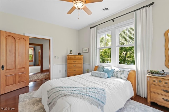 9627 State Route 152, Richmond, OH 43944 - bedroom featuring wood finished floors, a wainscoted wall, and ceiling fan