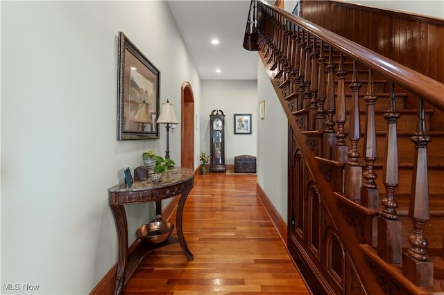 9627 State Route 152, Richmond, OH 43944 - hallway with wood finished floors, arched walkways, recessed lighting, stairway, and baseboards