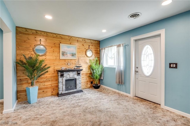 4944 Coleman Dr, Akron, OH 44319 - entryway with wood walls, carpet, recessed lighting, baseboards, and a stone fireplace