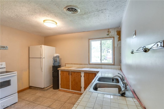 4944 Coleman Dr, Akron, OH 44319 - kitchen with white appliances, tile countertops, a sink, a textured ceiling, and light tile patterned flooring