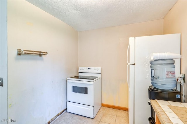 4944 Coleman Dr, Akron, OH 44319 - kitchen with tile counters, white appliances, a textured ceiling, baseboards, and light tile patterned flooring