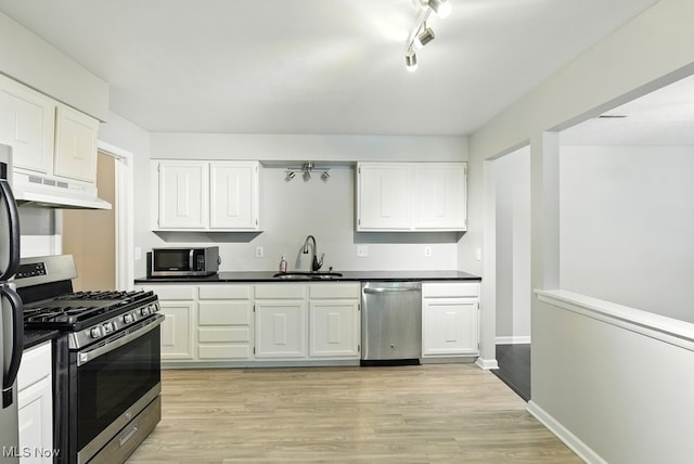 17682 Eastbrook Trl, Chagrin Falls, OH 44023 - kitchen with stainless steel appliances, a sink, under cabinet range hood, and dark countertops