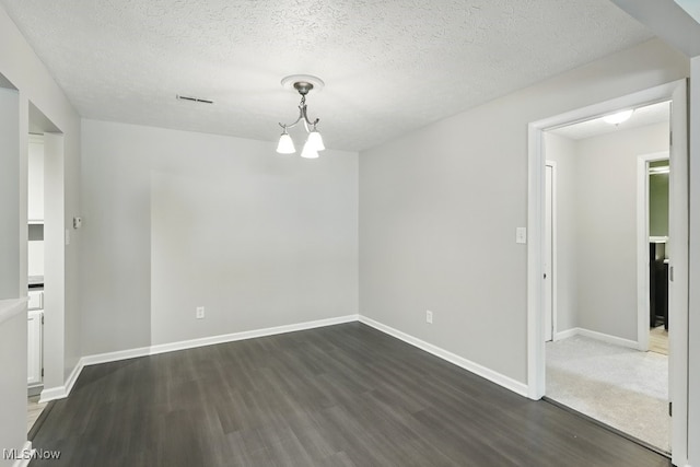17682 Eastbrook Trl, Chagrin Falls, OH 44023 - spare room with dark wood-style flooring, a chandelier, a textured ceiling, and baseboards