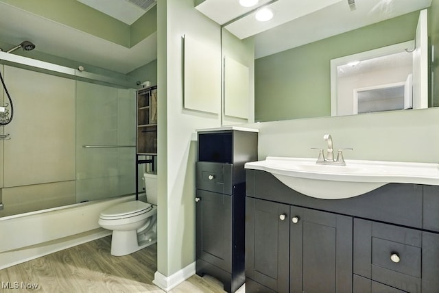 17682 Eastbrook Trl, Chagrin Falls, OH 44023 - bathroom featuring wood finished floors, vanity, combined bath / shower with glass door, and toilet