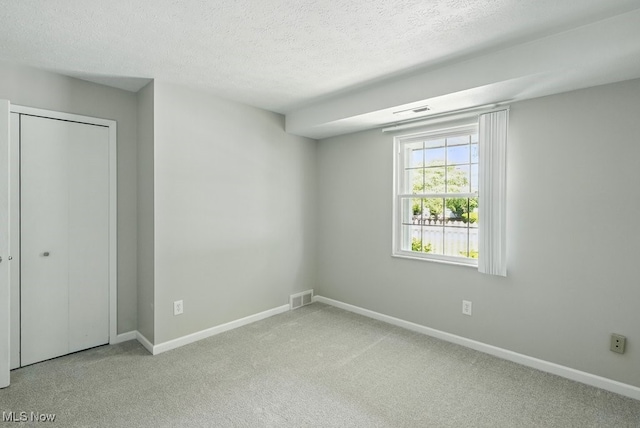 17682 Eastbrook Trl, Chagrin Falls, OH 44023 - unfurnished bedroom with carpet floors, baseboards, a textured ceiling, and a closet