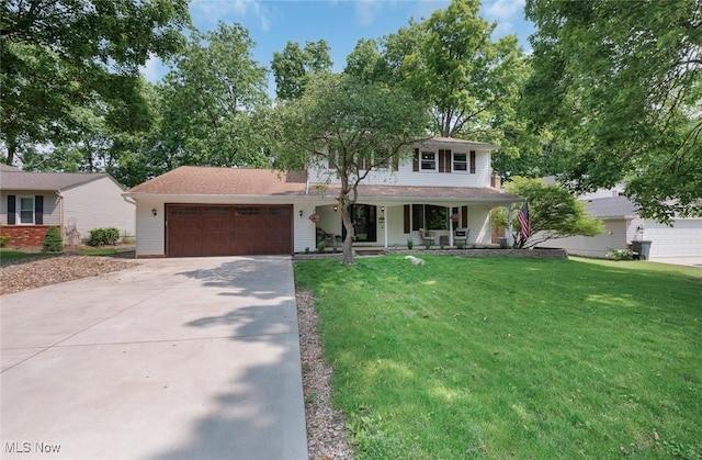 425 Woodlake Dr, Medina, OH 44256 - view of front facade featuring driveway, covered porch, an attached garage, and a front lawn