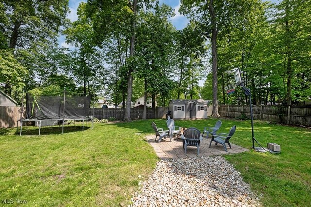 425 Woodlake Dr, Medina, OH 44256 - view of yard featuring a trampoline, a fire pit, and a patio area