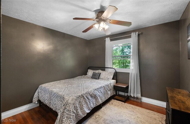425 Woodlake Dr, Medina, OH 44256 - bedroom featuring baseboards, wood finished floors, ceiling fan, and a textured ceiling