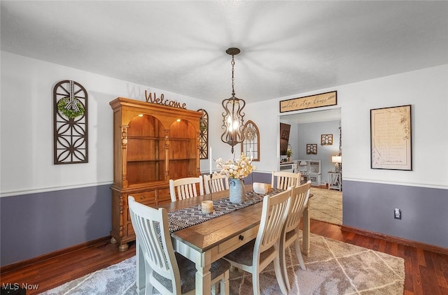 425 Woodlake Dr, Medina, OH 44256 - dining area with wood finished floors, a chandelier, and baseboards