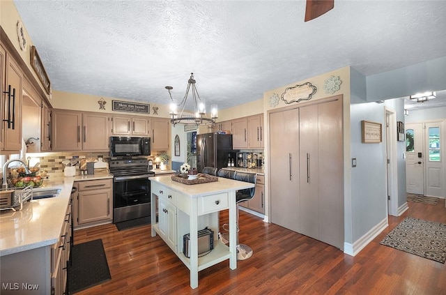 425 Woodlake Dr, Medina, OH 44256 - kitchen with black appliances, a sink, light countertops, a chandelier, and decorative backsplash