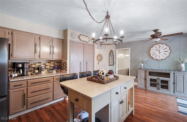 425 Woodlake Dr, Medina, OH 44256 - kitchen with light countertops, dark wood-style floors, a center island, tasteful backsplash, and a chandelier
