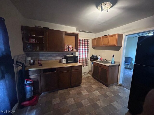 2411 Strasser Pl SW, Canton, OH 44710 - kitchen featuring freestanding refrigerator, light countertops, black microwave, and a sink