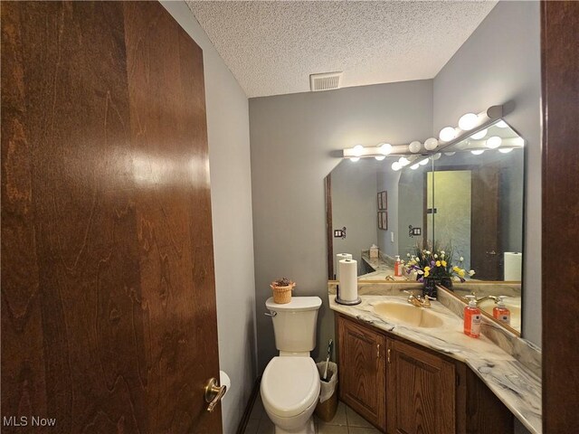 6671 Queens Way N, Royalton, OH 44133 - bathroom featuring vanity, a textured ceiling, toilet, and tile patterned flooring