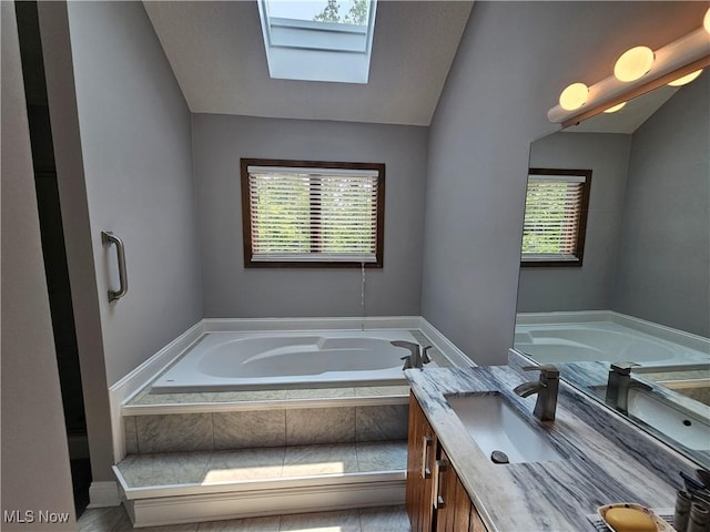 6671 Queens Way N, Royalton, OH 44133 - full bathroom with a garden tub, a skylight, vaulted ceiling, and double vanity
