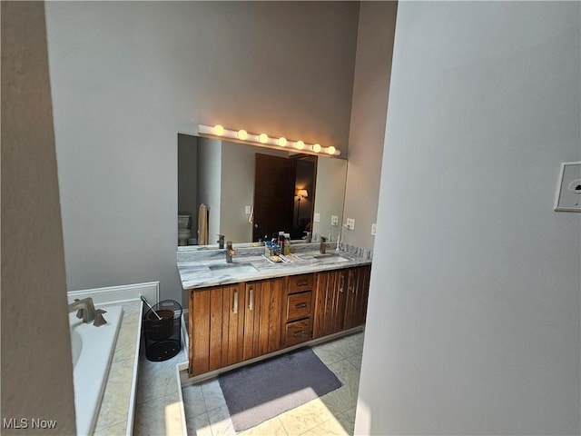 6671 Queens Way N, Royalton, OH 44133 - full bathroom with double vanity, a garden tub, and toilet