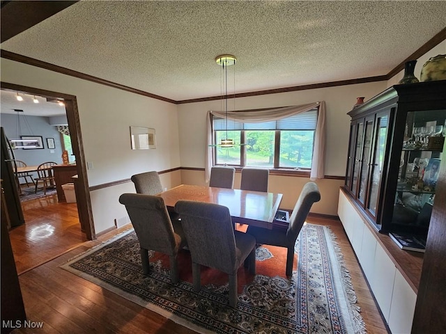 6671 Queens Way N, Royalton, OH 44133 - dining room with wood finished floors, ornamental molding, and a textured ceiling