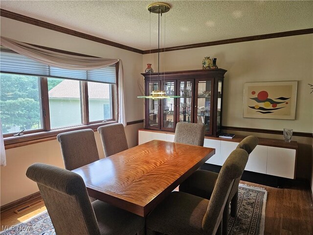 6671 Queens Way N, Royalton, OH 44133 - dining space with a textured ceiling, wood finished floors, ornamental molding, and baseboards