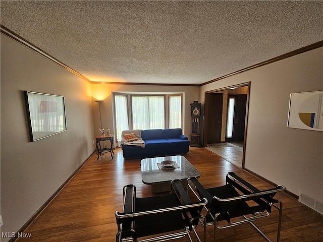 6671 Queens Way N, Royalton, OH 44133 - living room featuring ornamental molding, a textured ceiling, and wood finished floors