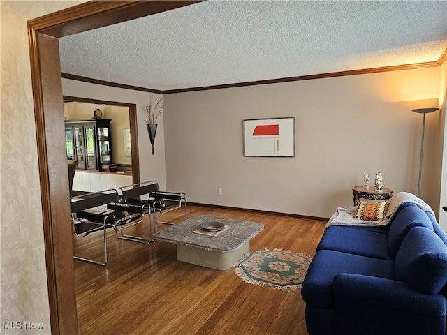 6671 Queens Way N, Royalton, OH 44133 - living room with wood finished floors, ornamental molding, a textured ceiling, and baseboards
