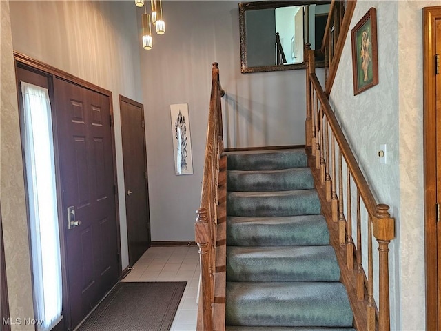 6671 Queens Way N, Royalton, OH 44133 - foyer featuring stairs, tile patterned floors, and baseboards